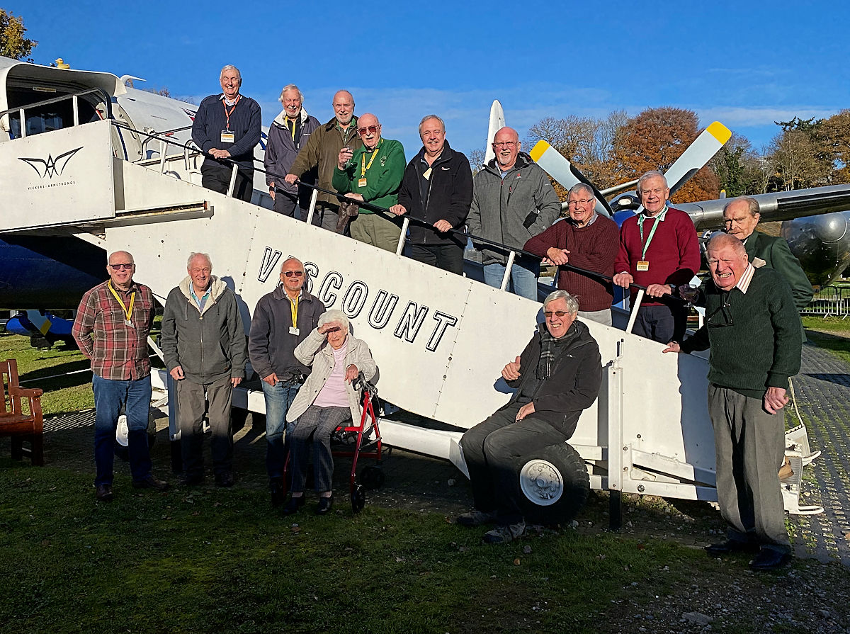 A group of VSP volunteers on and around the Viscount boarding steps at Brooklands Museum, with Stephen Piercey's mother and brother