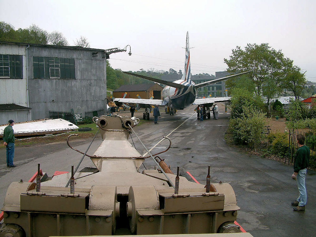The Brooklands Belle winching Viscount G-APIM tail-first through a narrow gap between buildings at Brooklands Museum